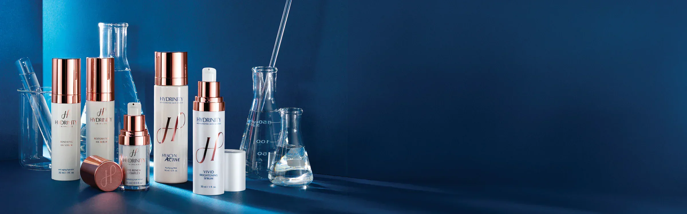 Hydrinity skincare products including Renewing HA Serum, Restorative HA Serum, Eye Renew Complex, Hyacyn Active, and Vivid Brightening Serum