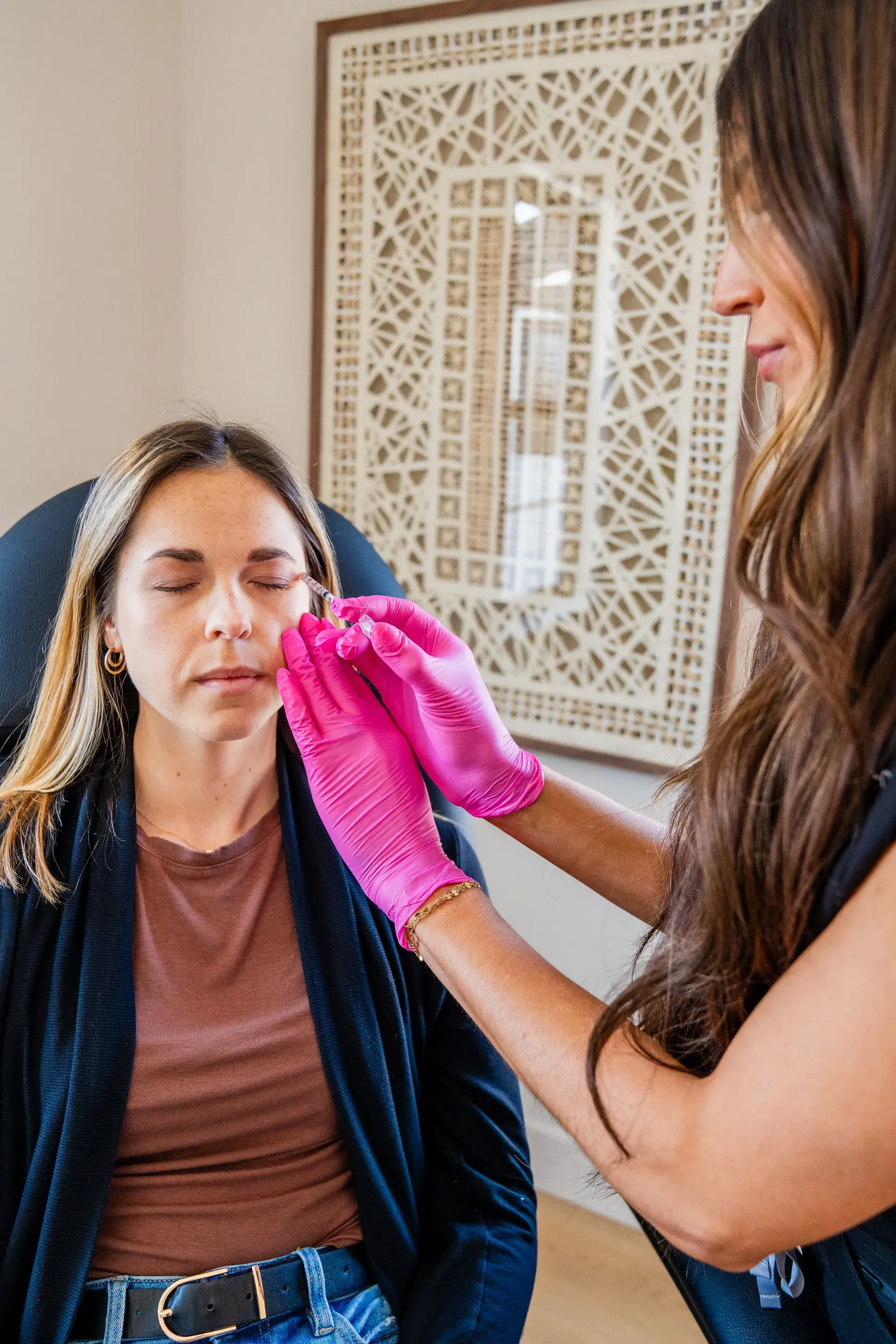 Nurse injector treating forehead and brow lines at Illume Aesthetics in Cottleville, Missouri